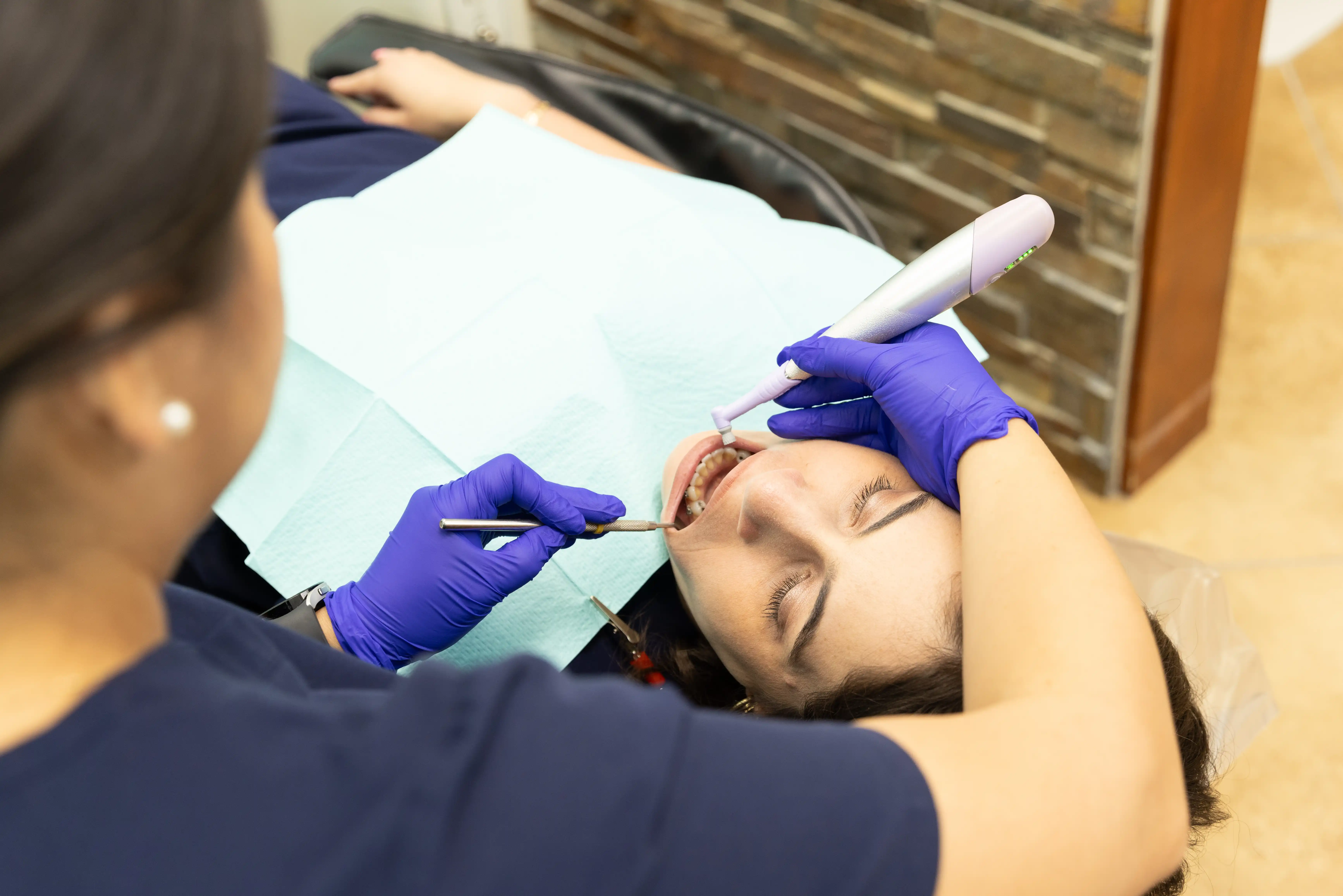 Hygienist preparing patient for a dental filling