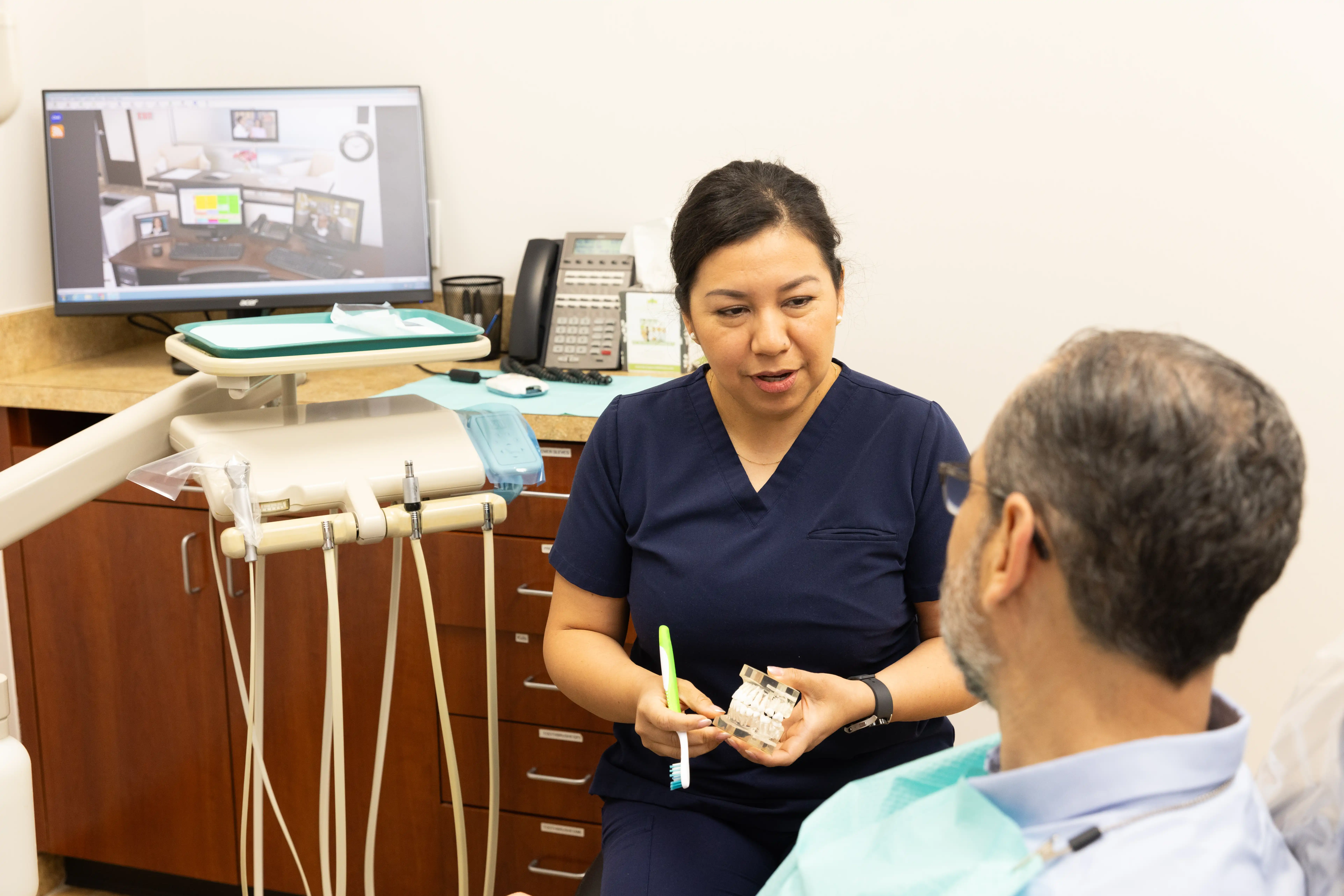 Hygienist explaining the benefits of TMJ treatment