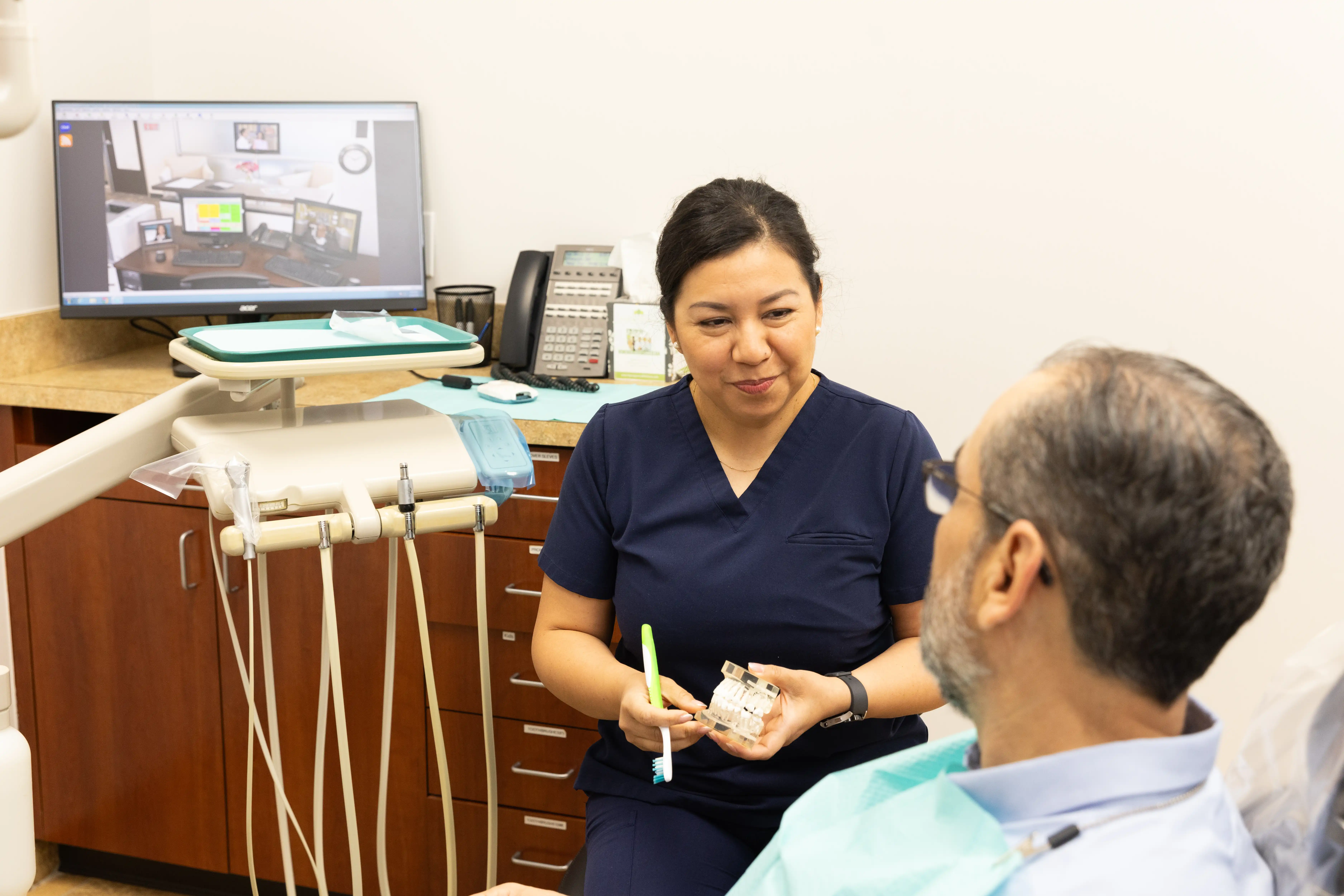Hygienist sharing post-surgery care tips with a patient