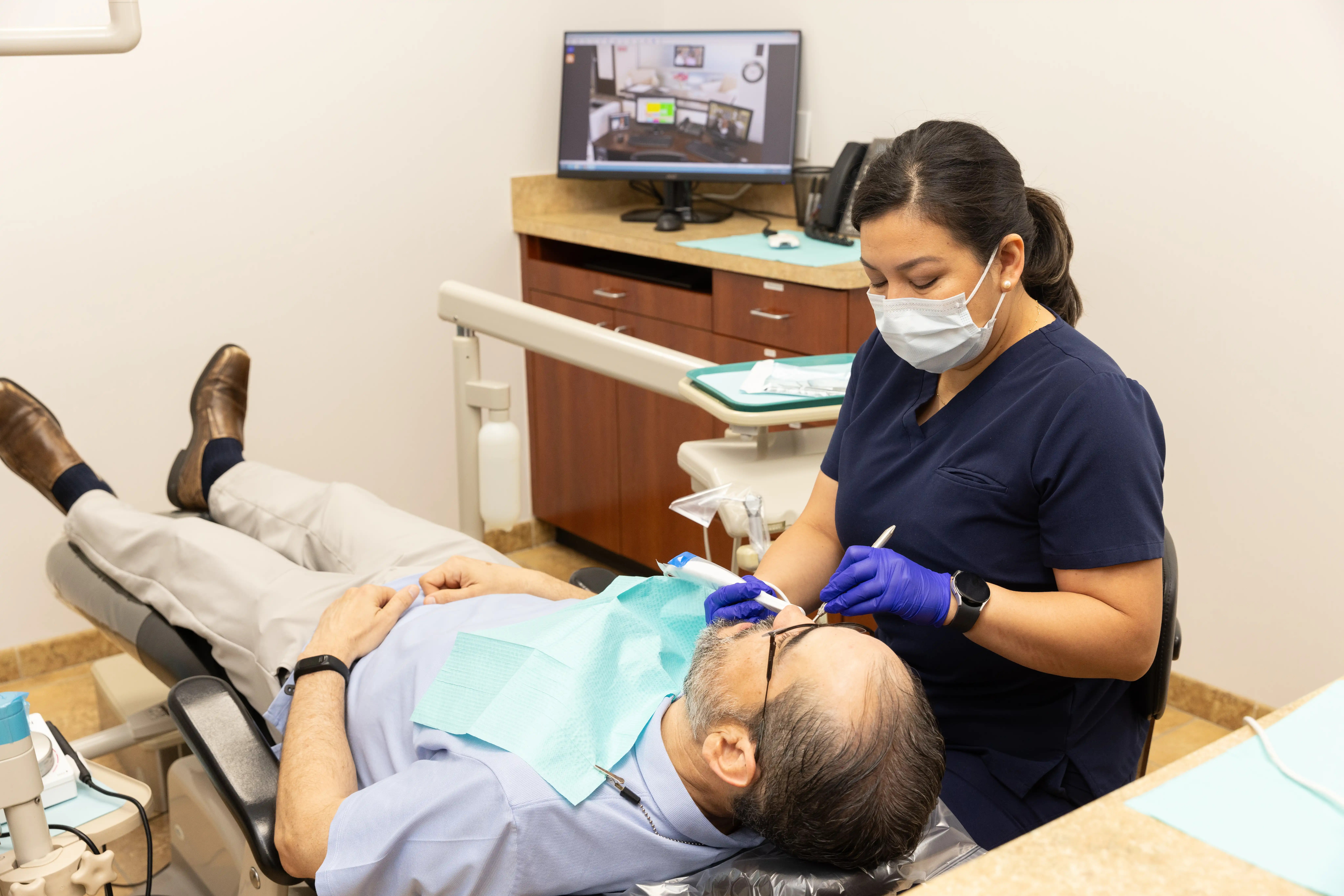 Hygienist preparing patient for wisdom tooth removal